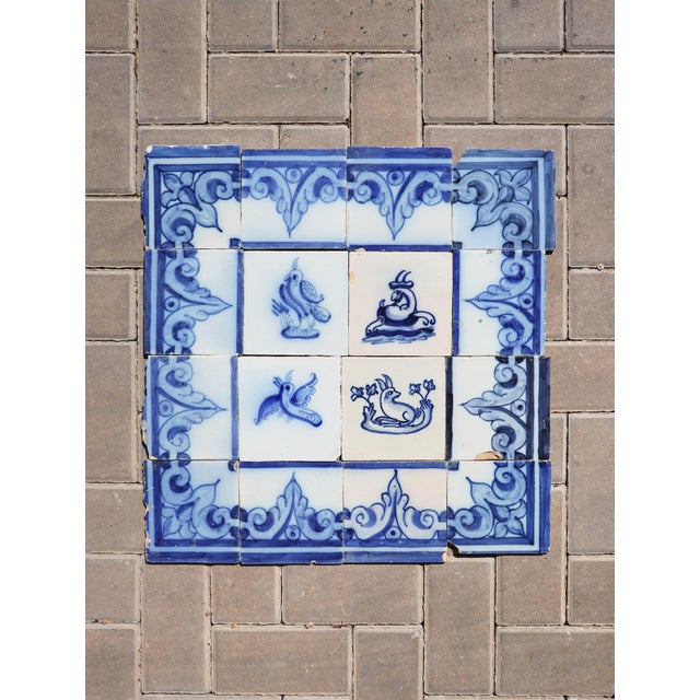 A 19th-century antique Portuguese tile mural panel depicting a parrot, another bird, a goat, and a rabbit, all surrounded...