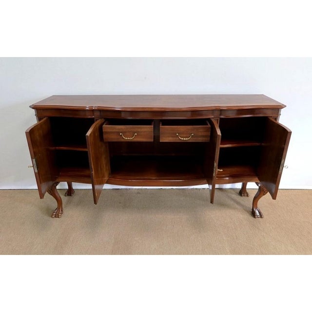 Sideboard whose top has a central part made of burr walnut veneer, a technique known as "four-leaf". It also has a frame...