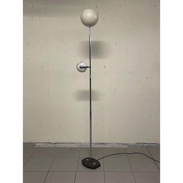 Floor lamp with top light and height-adjustable spotlight. Stilnovo, late 1960s, branded. Chromed brass frame, chromed and...
