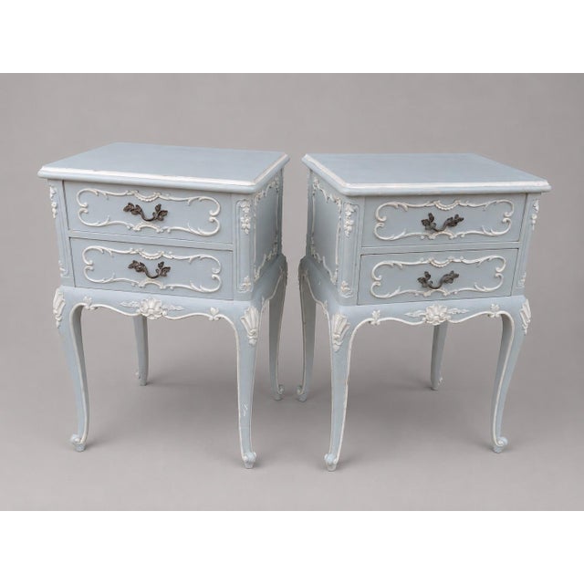 This charming matching pair of early 1900s French Louis XVI–style nightstands combines authentic antique character with a...