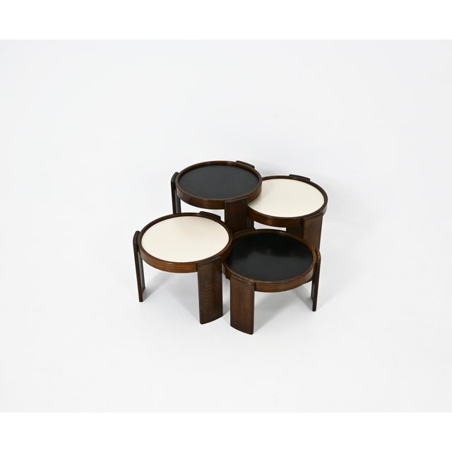 Wooden nesting table. Reversible black and white top. Stamped Cassina. Wear due to time and age of the table. Measures:...