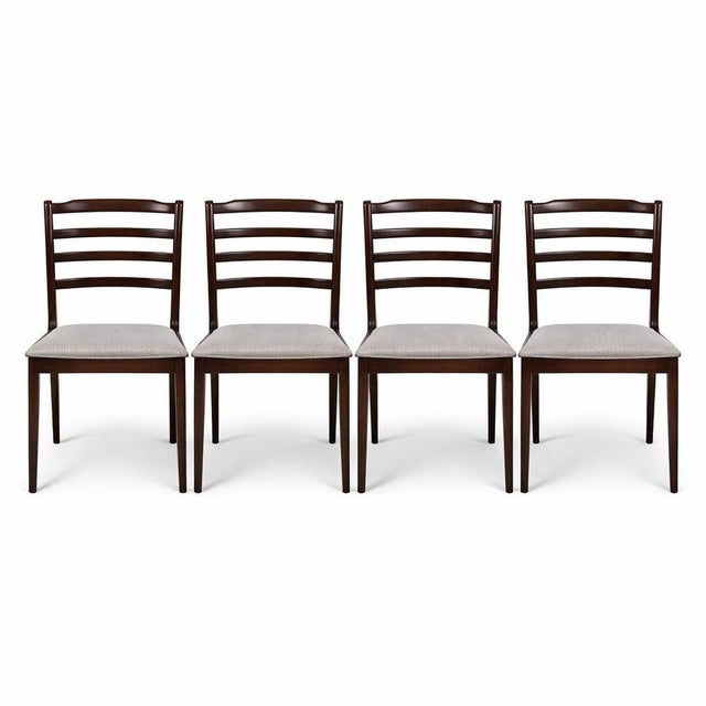 A beautiful set of four Danish mid-century ladderback dining chairs, crafted in richly grained rosewood and showcasing the...