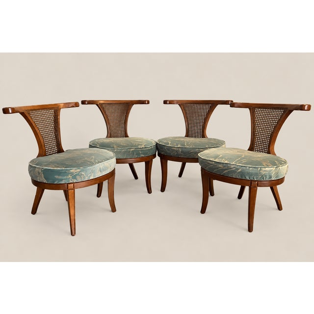 Offered is a set of four wood chairs attributed to William "Billy" Haines. The curved backs are caned. This chic set is...