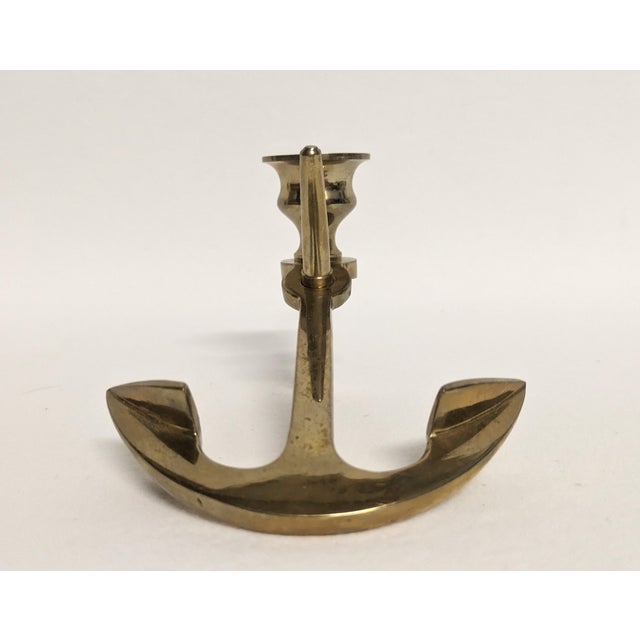 A vintage brass anchor shaped candle holder. The candlestick holds one taper. A great nautical addition to your decor. It...