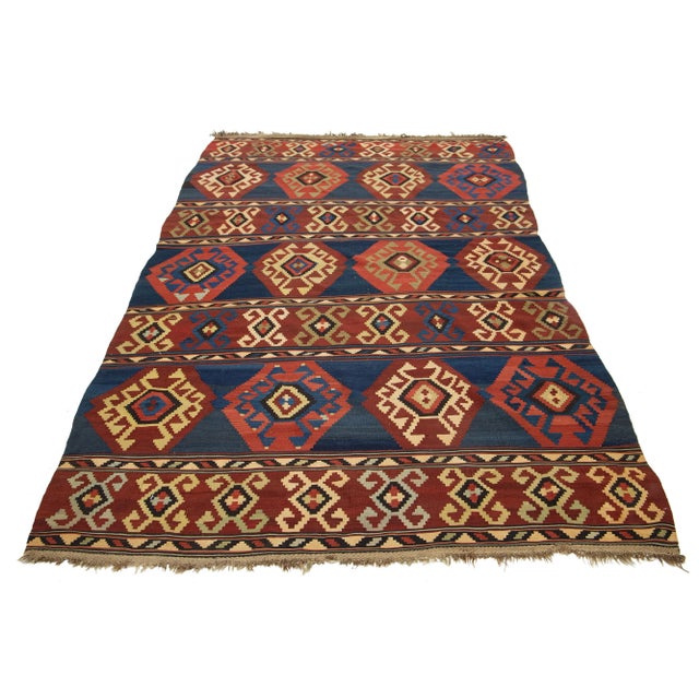 Introducing a beautiful vintage kilim wool rug, meticulously hand-knotted with a captivating geometric design in rust and...