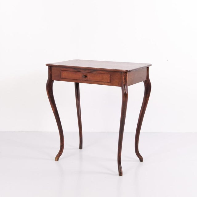 Mahogany side table with a drawer and elegantly curved legs. Dating from around 1910, the table features a classic design...