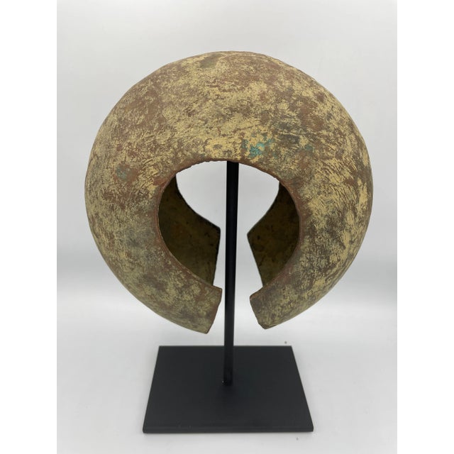 Copper form from the Mbole people of Central Africa. Displayed on a custom metal stand, the piece has a striking modern...