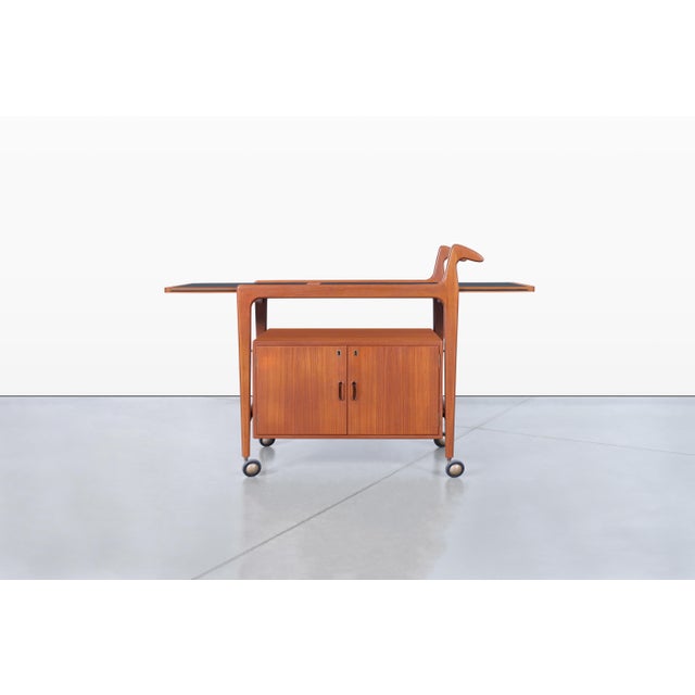A stunning example of 1960s Danish modern design, this teak bar cart by Falster Mobelfabrik embodies the timeless elegance...