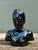 This evocative vintage male bust is a sophisticated study in form and finish. Rendered in a high-gloss "piano black"...