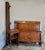 A pair of Italian Louis XVI–style twin beds with matching nightstand, crafted in richly figured flame birch veneers with...