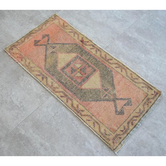 an Vintage small rug. Medium wood background color yastik rug perfect for a small guest bath or in front of the kitchen...