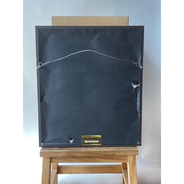 Framed Salvatore Dali etching in a gold tone frame with a green-gray tonal mat.