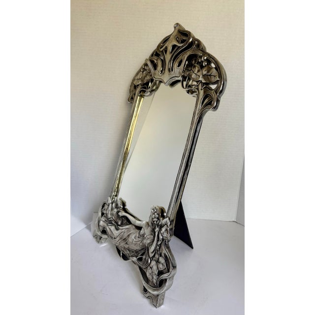 Here is a striking vintage Art Nouveau-style figural mirror, likely dating to the mid-20th century. This piece is a later...