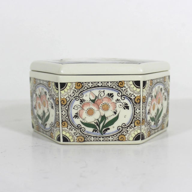 Vintage hexagonal hand painted ceramic lidded box. This has a scene with a windmill and sailboat on the lid and a floral...