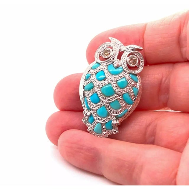 This is an adorable pendant and brooch, it is crafted from 18k white gold featuring an owl with turquoise body and tail...
