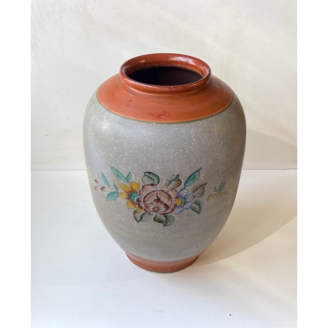 Large monumental terracotta/earthenware vase fully glazed in dusty grey and caramel tones. Decorated with hand-painted...