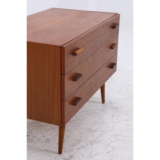 Beautiful Mid-Century Teak Chest of Drawers Item • Made in Denmark • Three spacious drawers • Simple, geometric handle...