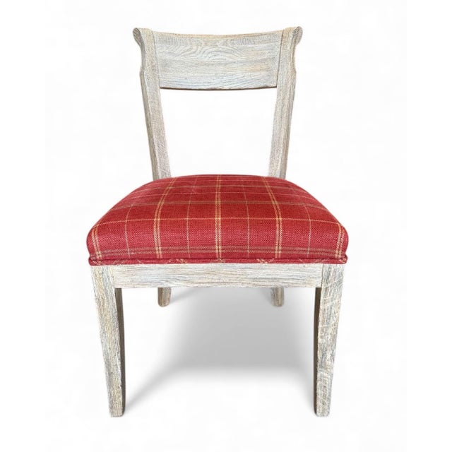 Set of 8 Regency style side chairs with cerused finish. The seats are upholstered in vermillion tan and beige window pane...