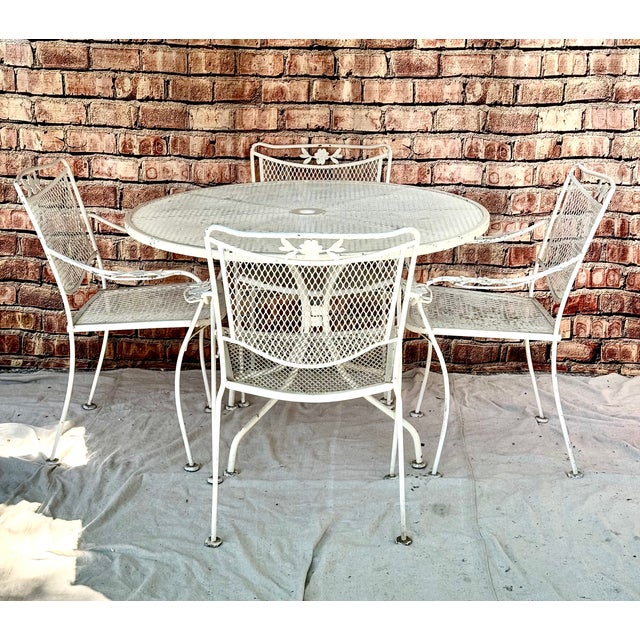Five piece Mid-Century Wrought Iron Patio set in the style of Salterini. Featuring table and four chairs. 42" round table...