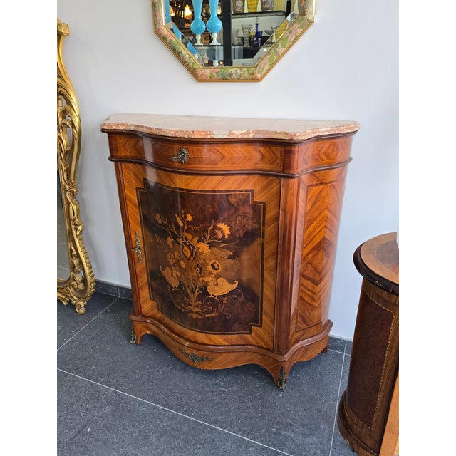 A superb antique louis xv style side table with a curved front, crafted in fine marquetry and topped with a pinkish-veined...