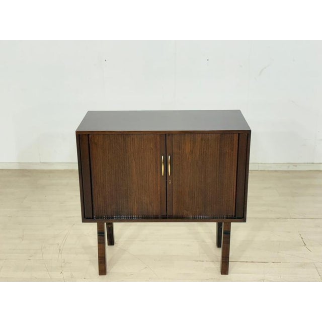 For sale is a stylish vintage chest of drawers from the 1960s. This piece of furniture impresses with its simple mid-...