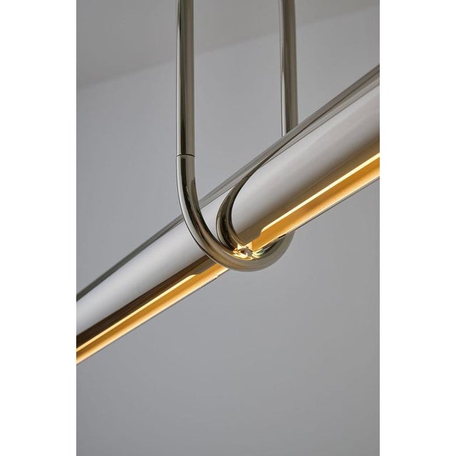 Oblong calame pendant lamp by jennifer midoz dimensions: d 84,5 × w 8,5 × h 50 cm materials: pale gold on polished brass,...