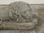 A pair of English cast stone reclining lions statues from the early 20th century, on rectangular bases. Created in England...