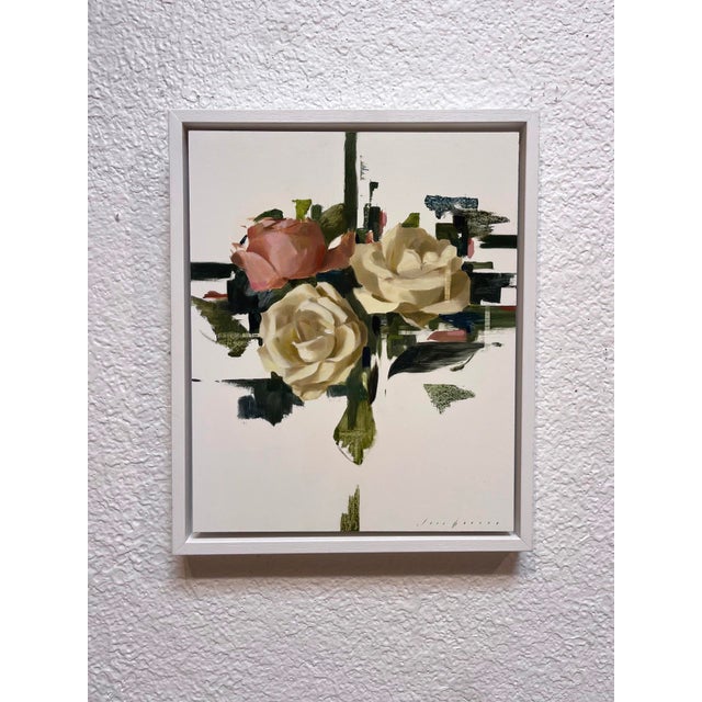 This oil painting features two elegantly rendered roses, one soft pink and the other creamy white, set against a backdrop...