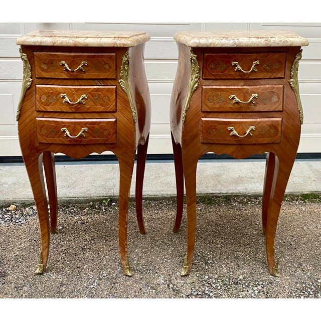 Two Louis XV style bedside tables/nightstands in rosewood marquetry. Three drawers. Excellent condition. Authentic, with...
