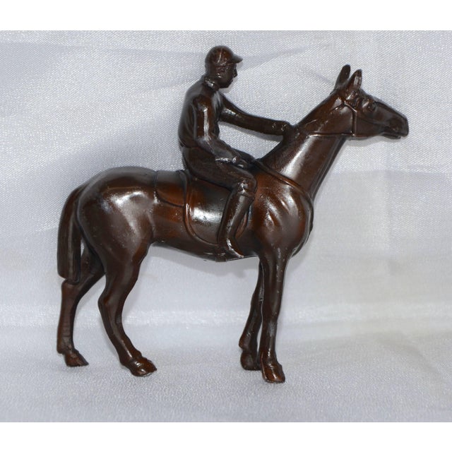 This is a nice miniature cast metal horse and rider with a bronze finish. It is marked on the underside, made in Japan....