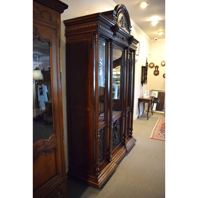 19th-Century French Walnut Henri II Triple Door Bookcase/Cabinet with the original beveled glass, raised paneled sides and...