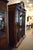 19th-Century French Walnut Henri II Triple Door Bookcase/Cabinet with the original beveled glass, raised paneled sides and...