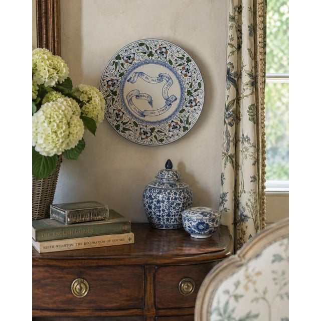 A charming vintage Italian decorative plate from Faenza, hand painted in a traditional palette of cobalt blue, leafy...