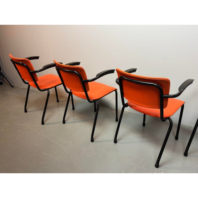 Set of four Mid-Century dining chairs designed by Arend de Cirkel. The chairs feature fresh orange leatherette upholstery...