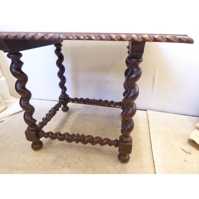 Jacobean style low table with rope twist legs and cross bar, incised decoration on top, Walnut stained, label on underside...
