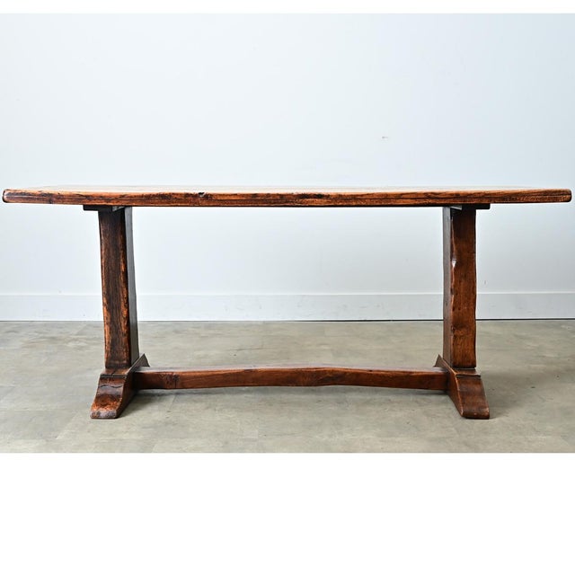 An 18th-century French solid elm farm table, perfect for anchoring a dining room or workspace. The top is made from four...