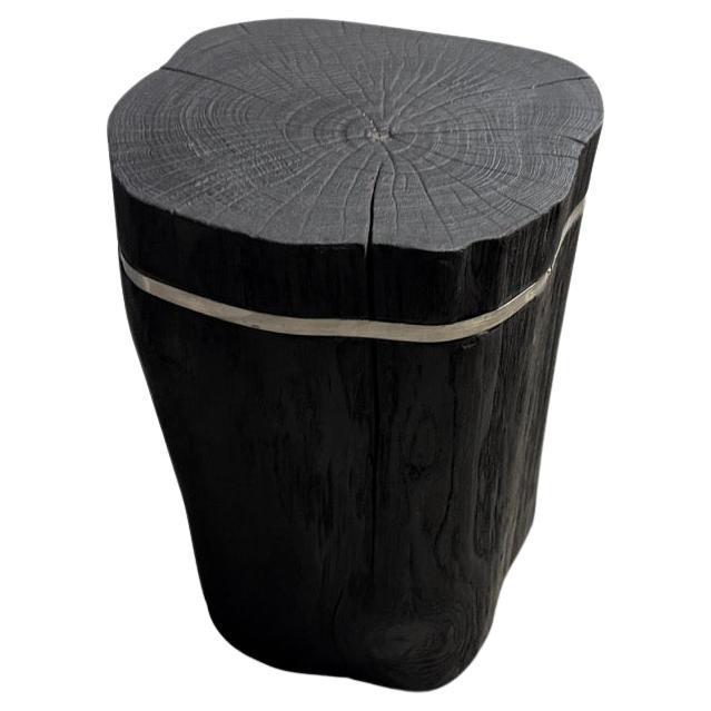 Minimalist reclaimed teak wood side table with a thin silver stainless steel inlay. Charred, sanded and sealed revealing...