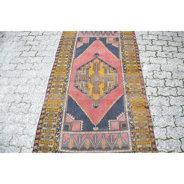 This is a vintage Turkish Oushak rug from the 1960s. The piece was hand-knotted.