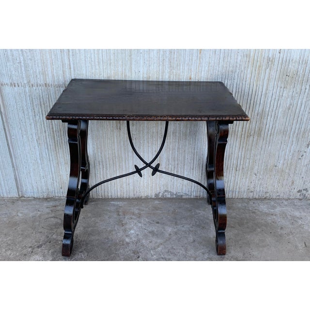 19th century Spanish side table with hand carved lyre leg and iron stretcher. Exquiste antique hand carved lyre-leg walnut...