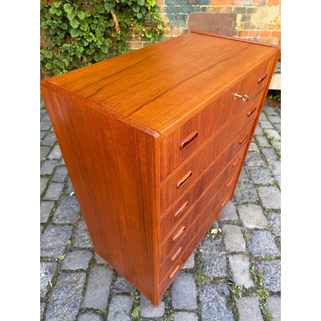 Danish craftsmanship of the 1960s: This teak chest of drawers from Denmark combines functional ingenuity with...