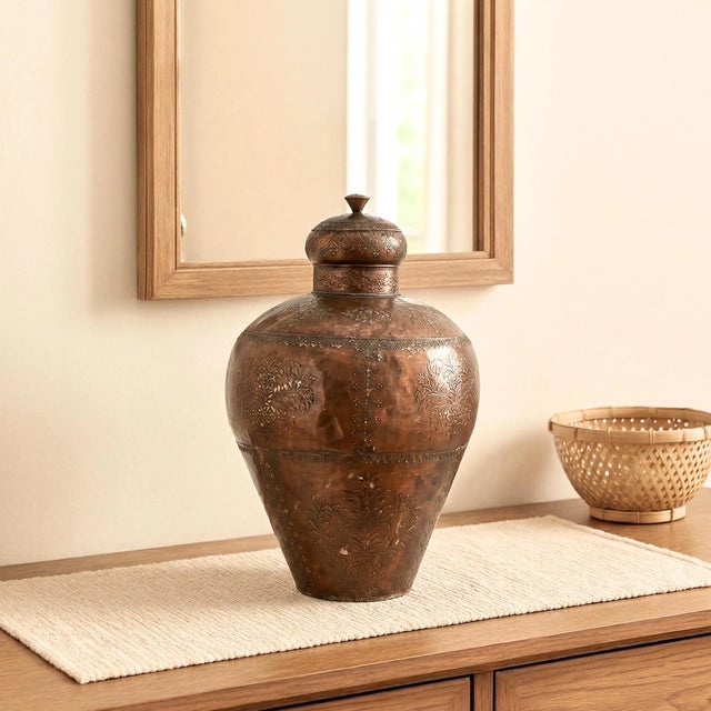 Elevate your interior with a piece that whispers stories of a storied past. This Large Vintage Copper Floor Vase with Lid...