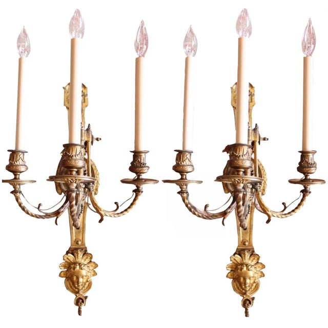 A pair of large late 19th century three light sconces, with an abundance of cast and gilt bronze classical detail. Fine...