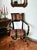 A striking Italian armchair combining neoclassical influences with bold decorative character. The chair features a black...