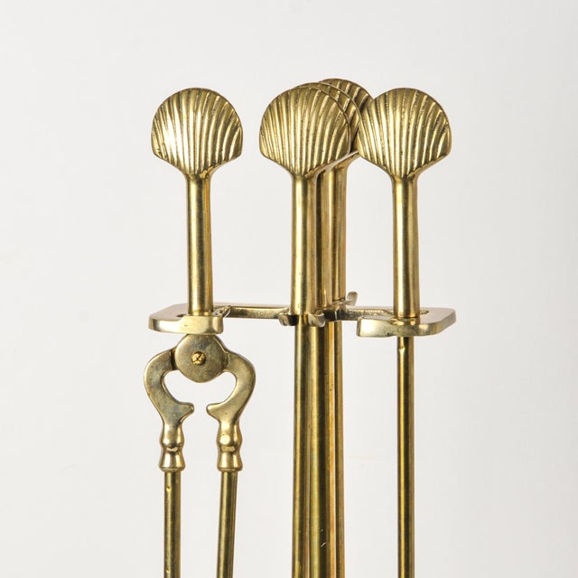 Incredible vintage brass fireplace tool set featuring matching scallop shell handles and shell base on the stand. This...