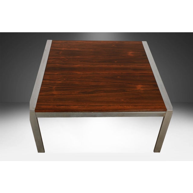 An exceptional MidCentury rosewood and chrome, square Milo Baughman style coffee table. It is designed in the classic...