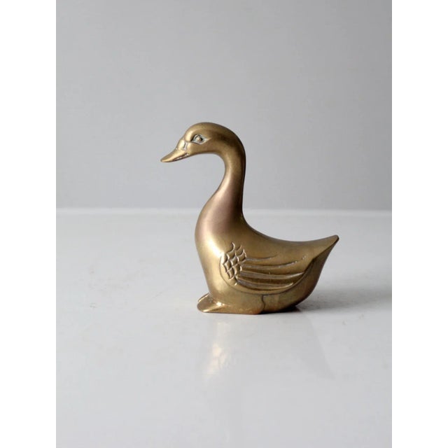 Striking mid-century brass goose sculpture with a substantial, heavy-weight feel and beautifully stylized lines. The...