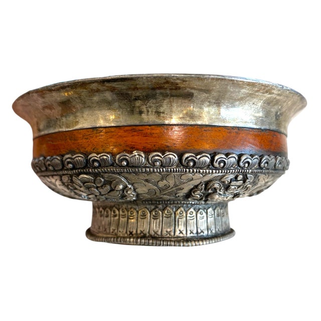 This is a beautiful antique Tibetan silver-mounted wooden bowl featuring stunning repoussé decoration of the Eight...