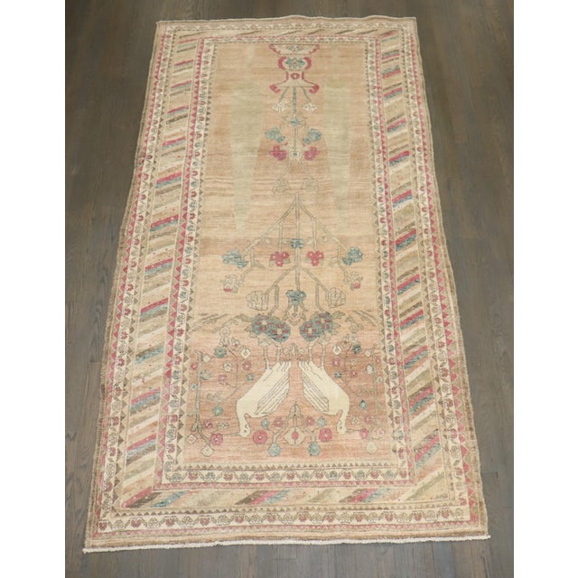 a 1940s Persian Bidjar feminine color 2 pigeon rug with green and raspberry accent colors on a neutral ground