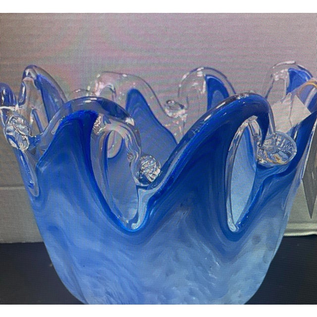 Beautiful Italian art glass decorative bowl featuring rich blue tones and an eye-catching sculptural form. The substantial...