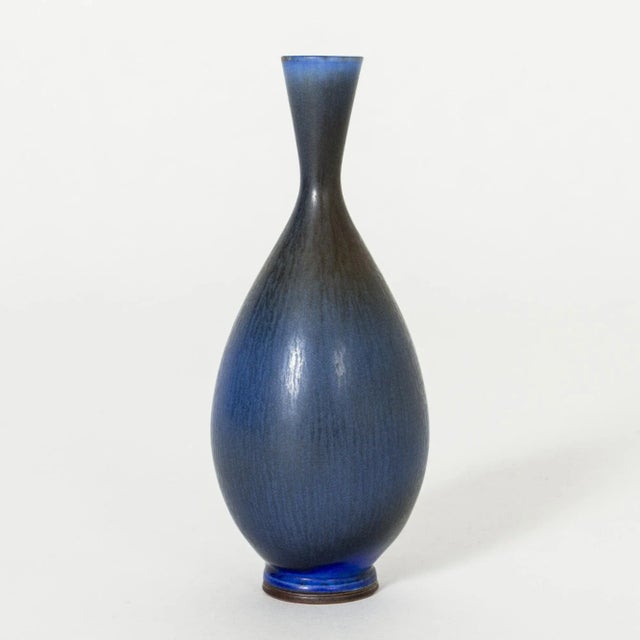 Beautiful, small stoneware vase by Berndt Friberg, in a curvesome form with blue hare’s fur glaze, blending into darker...